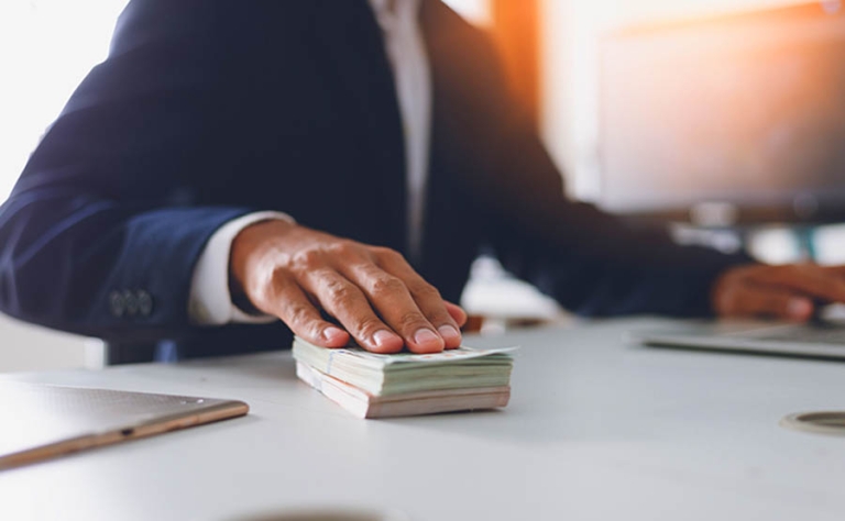 Turn Your Stocks into Cash Without Saying Goodbye to Your Portfolio;The concept of bribery and compensation.BusinessMan offering bills.